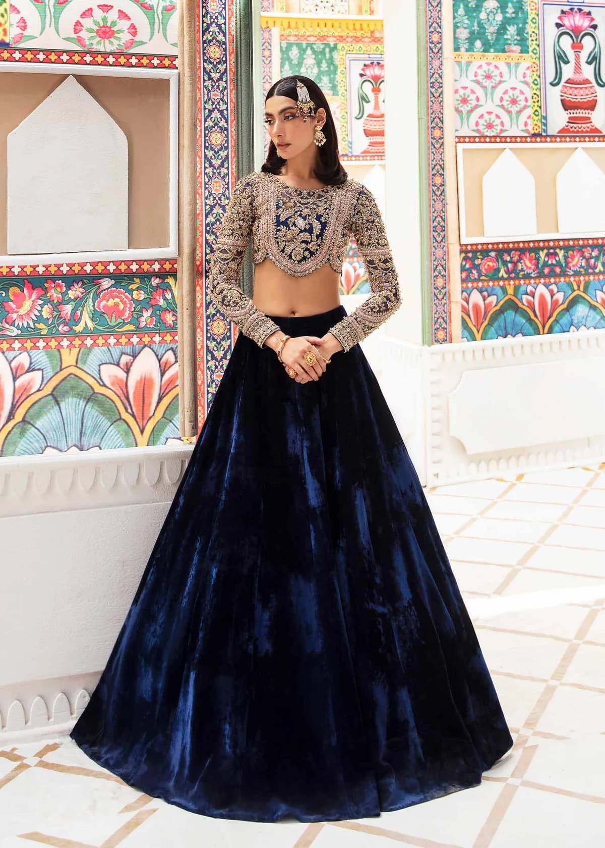 Nandini royal blue velvet lehenga with heavily embellished organza choli, full-length front view