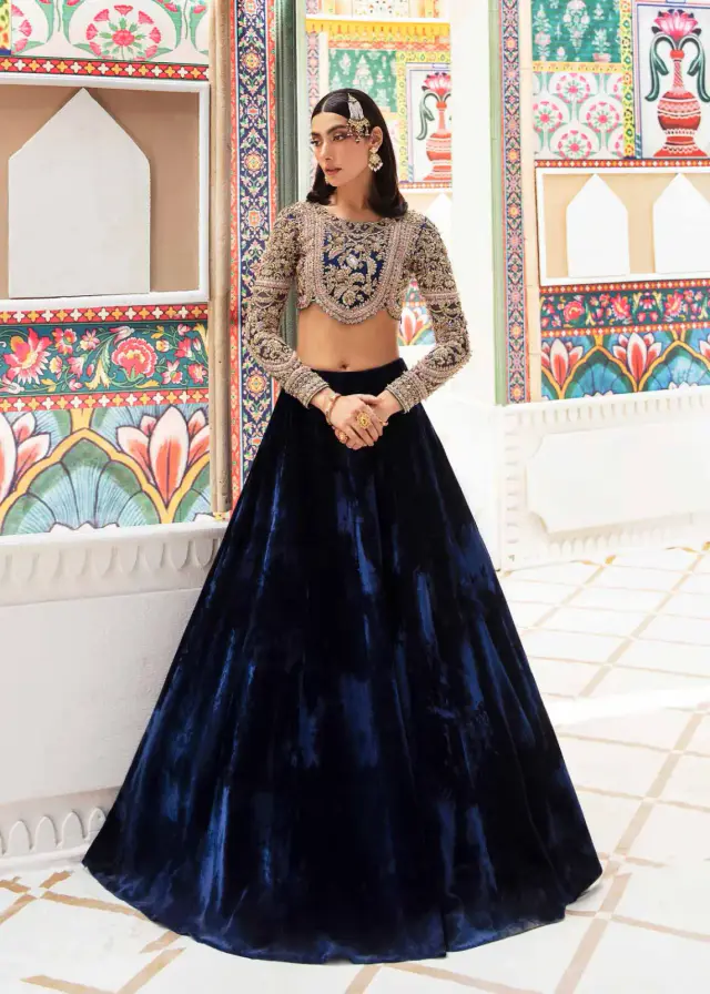 Nandini royal blue velvet lehenga with heavily embellished organza choli, full-length front view