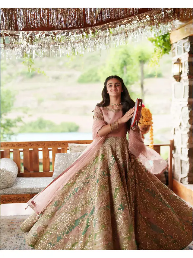 Sosan rosewood pink and sage green bridal lehenga choli, full length seated view