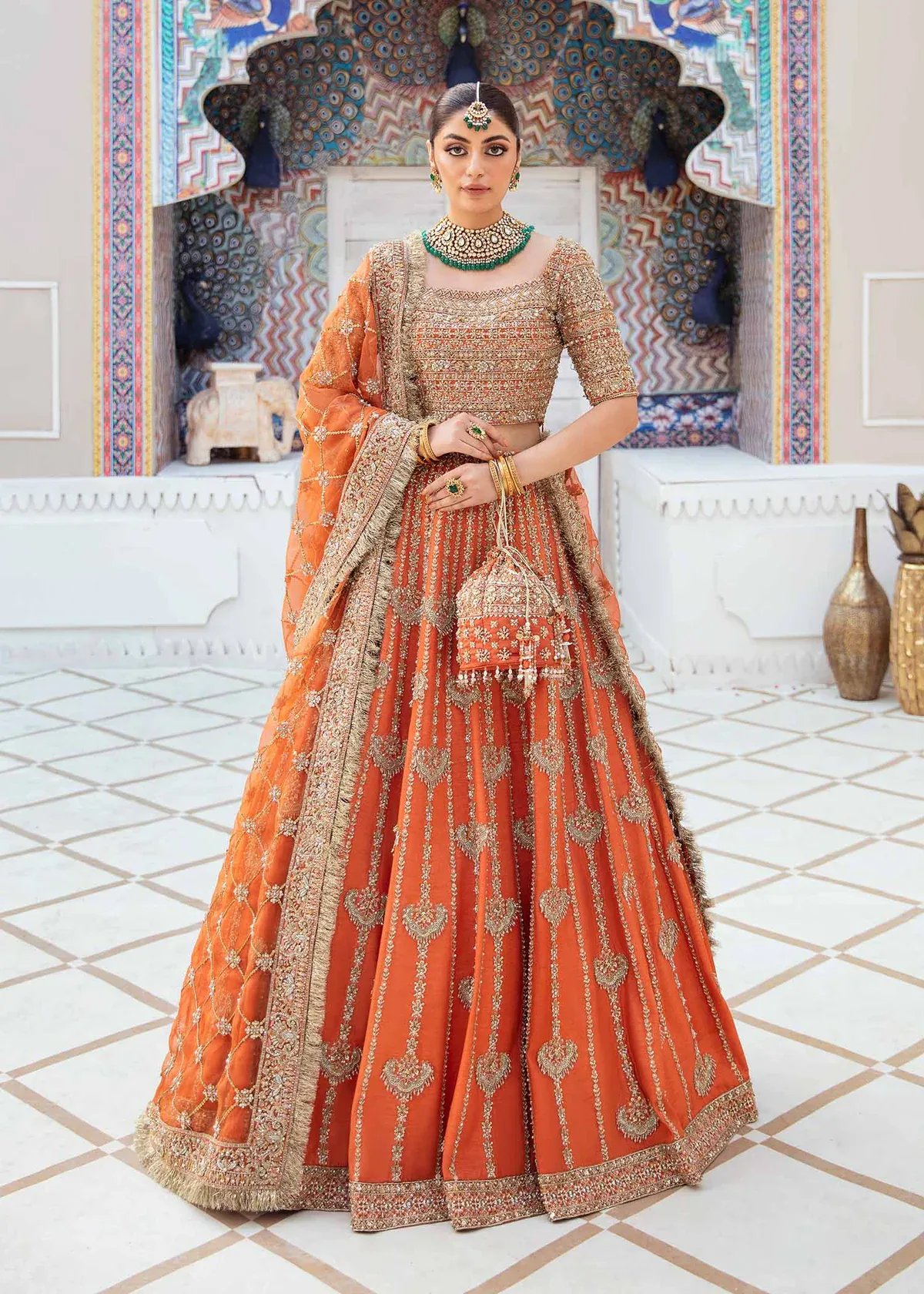 Kesar orange raw silk lehenga choli with gold embellishment, full-length front view